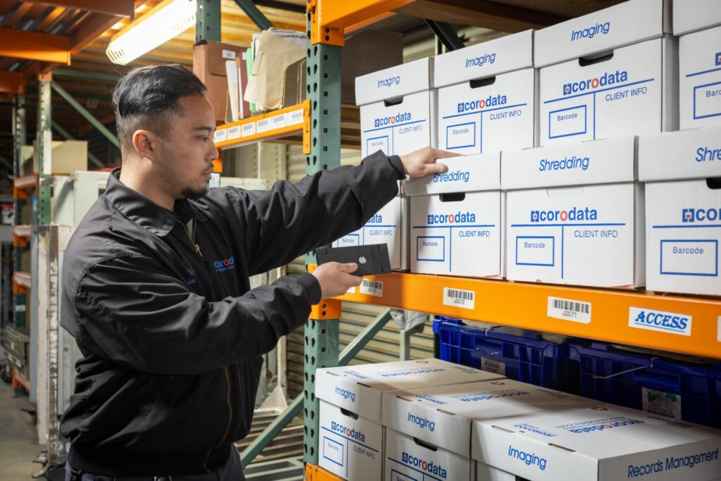 a warehouseman scanning Corodata boxes