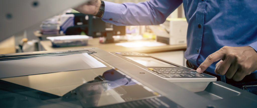 Copier printer, Close up hand office man press copy button on panel to using the copier or photocopier machine for scanning document printing a sheet paper and xerox photocopy.